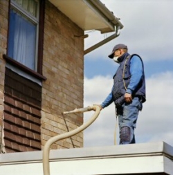 Man injecting cavity wall insulation
